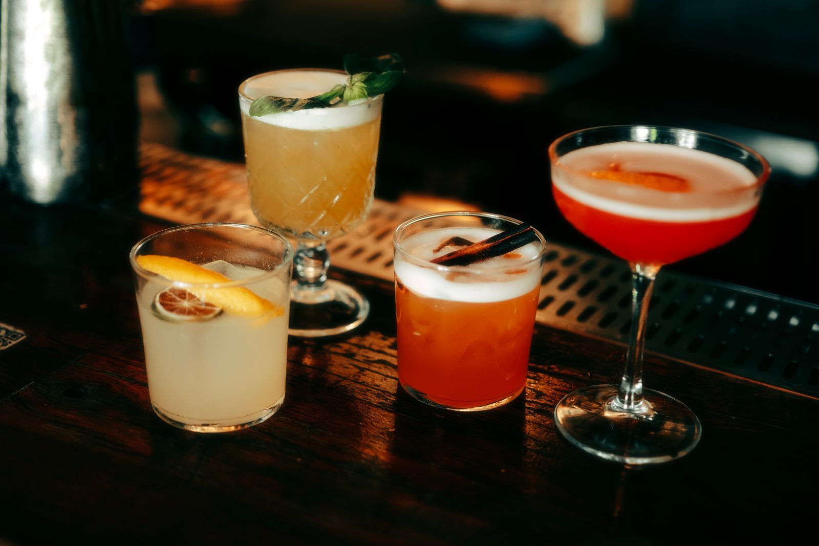 A selection of colourful cocktails on a bar