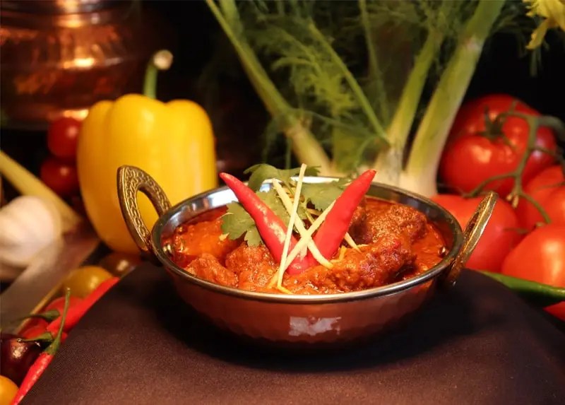 Indian curry served with fresh garnishes